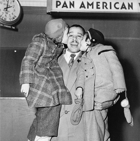 1951 Cab Caloway and children at at Pan Am ticket counter.